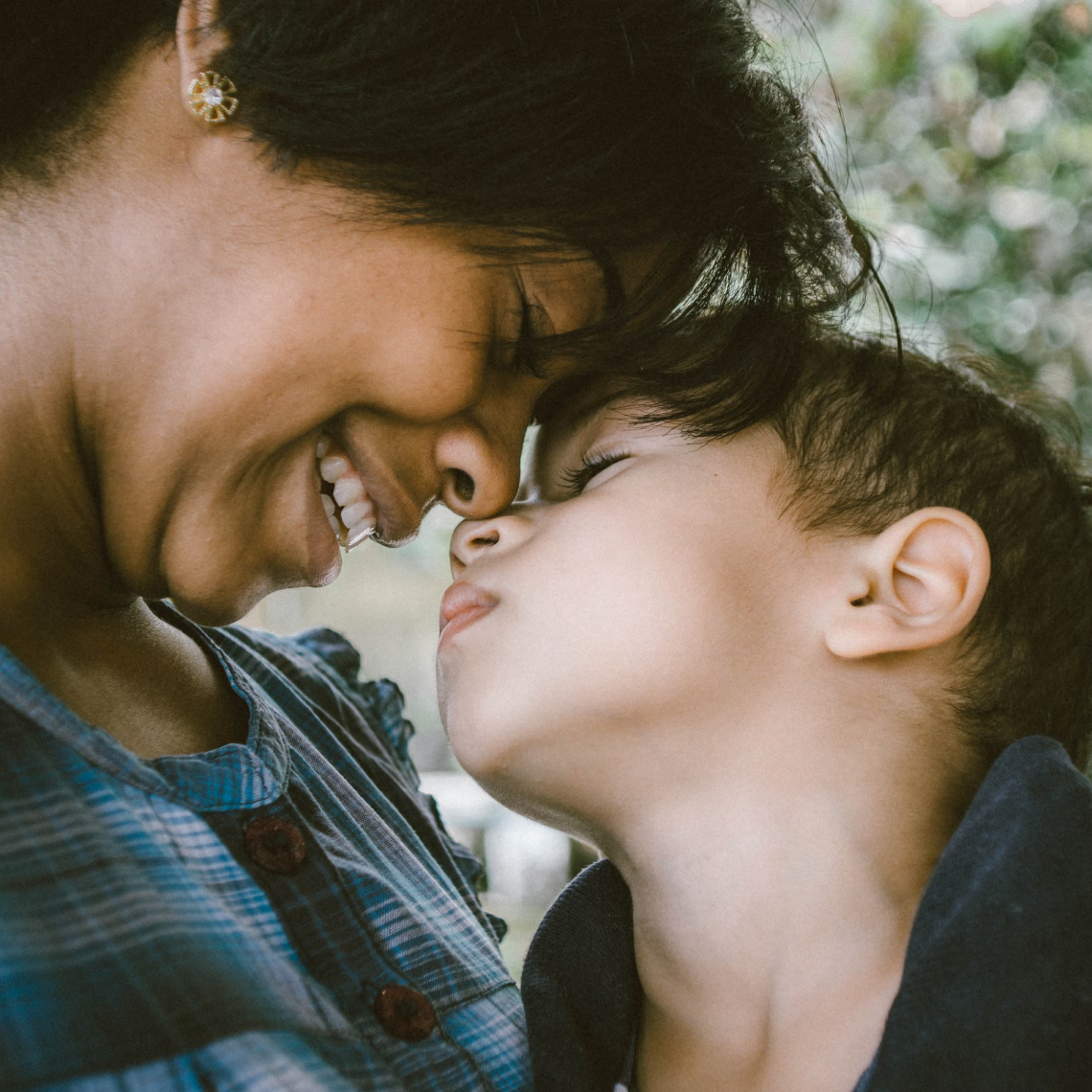 Photo of a Mother and Son smiling at each other, by Bruno Nascimento, Unsplash